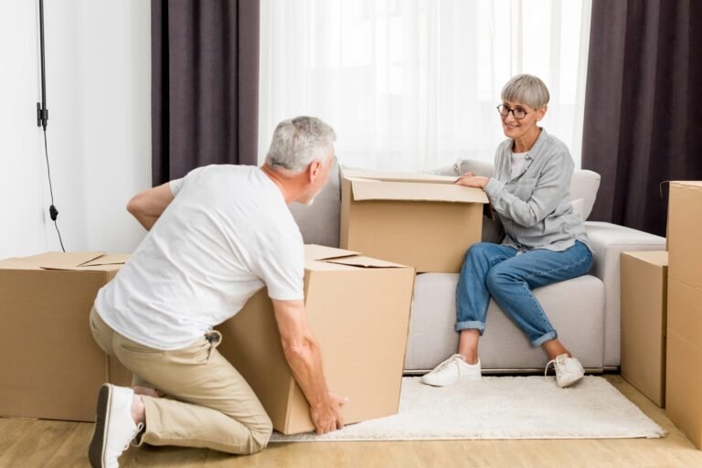 mature man holding box and woman sitting on sofa i 2023 11 27 05 26 16 utc
