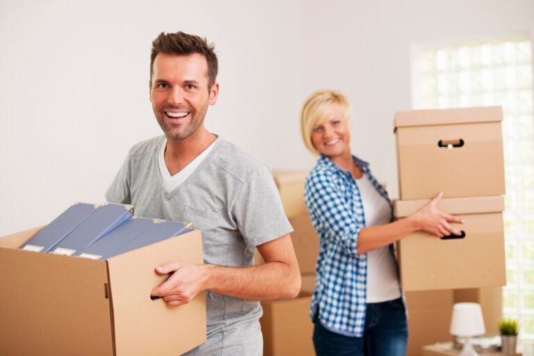 portrait happy couple carrying cardboard boxes new home 329181 145