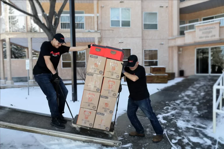 two local movers loading boxes in truck